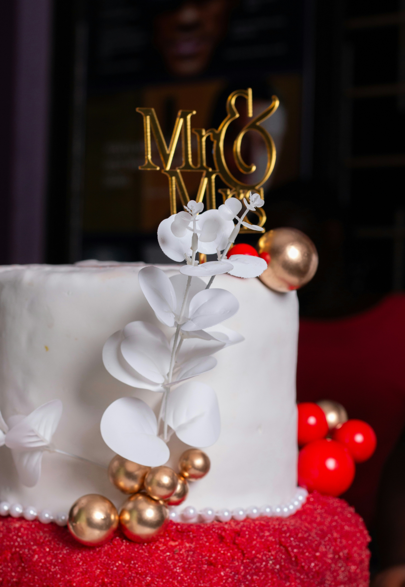 White and red celebration cake with gold detailing